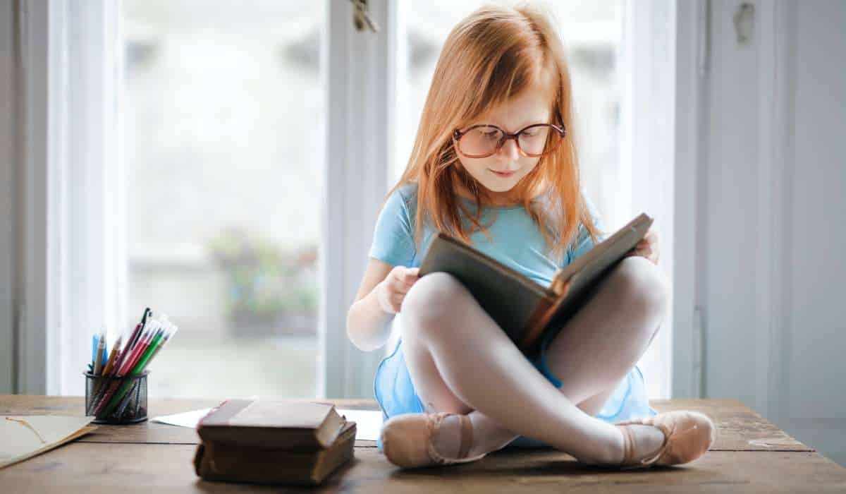 Girl wearing glasses reading a book